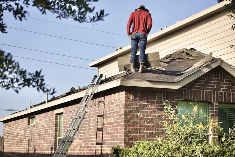 Professional roofer working on a residential roof in North Common